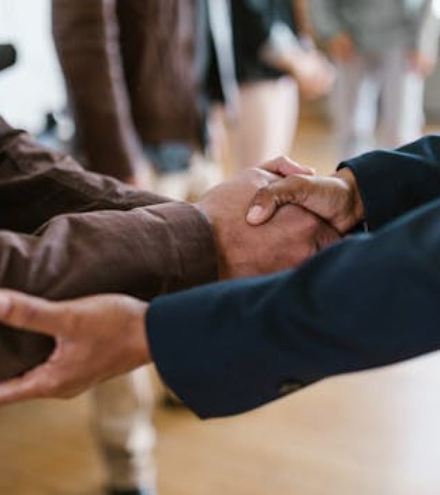 pexels-photo-7414284-7414284-1 Close-up of two businesspeople shaking hands, symbolizing agreement and partnership.